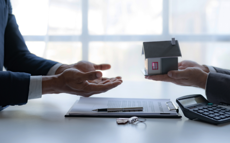 A meeting of between a real estate agent and a client closing a real estate transaction.